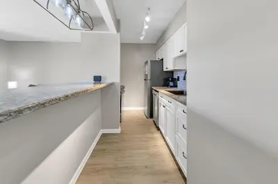 a kitchen with white cabinets and a counter top at Endless Summer E2 in Panama City Beach