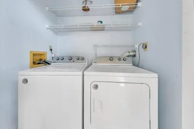 two washing machines sitting next to each other in a kitchen at Cassine Gardens 212 in Santa Rosa Beach