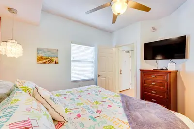 a bedroom with a bed and a flat screen tv at Panama City Beach Paradise with Pool and Hot Tub! in Panama City Beach