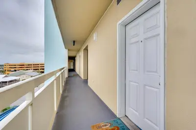 a corridor of a building with a white door at Panama City Beach Paradise with Pool and Hot Tub! in Panama City Beach