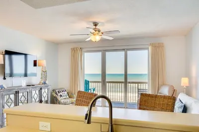 a living room with a view of the ocean at Panama City Beach Paradise with Pool and Hot Tub! in Panama City Beach