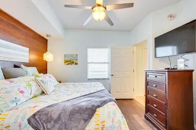 a bedroom with a bed and a flat screen tv at Panama City Beach Paradise with Pool and Hot Tub! in Panama City Beach
