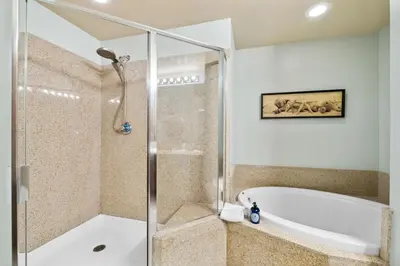 a bathroom with a shower and a bath tub at Laketown Wharf #1106 by Nautical Properties in Panama City Beach