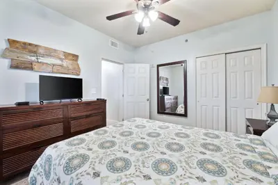 a bedroom with a bed and a flat screen tv at Laketown Wharf #1106 by Nautical Properties in Panama City Beach