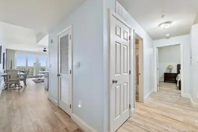 a hallway with white doors and a dining room at Laketown Wharf #1106 by Nautical Properties in Panama City Beach