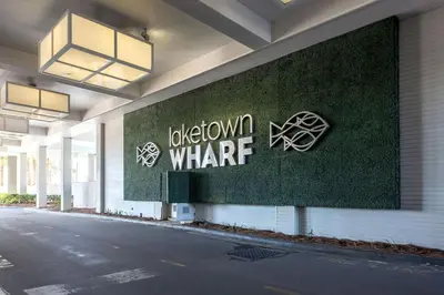 a building with a sign on the side of it at Laketown Wharf #1106 by Nautical Properties in Panama City Beach