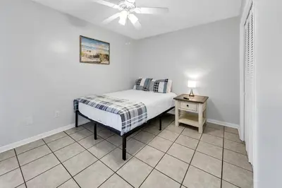 a bedroom with a bed and a ceiling fan at Endless Summer B4 in Panama City Beach