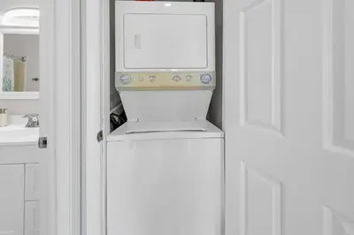 a washer and dryer sitting on top of a refrigerator at Endless Summer B4 in Panama City Beach