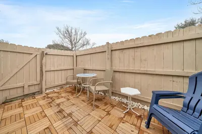 a patio with a table and chairs on a fence at Horizon South 11C1 in Panama City Beach