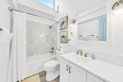 a white bathroom with a toilet and a sink and a shower at Horizon South 11C1 in Panama City Beach
