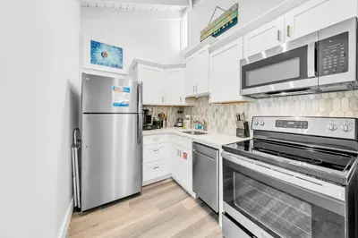 a kitchen with white cabinets and stainless steel appliances at Horizon South 11C1 in Panama City Beach