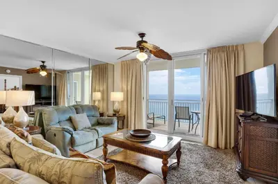 a living room with a couch and a tv at Emerald Beach 930 in Panama City Beach