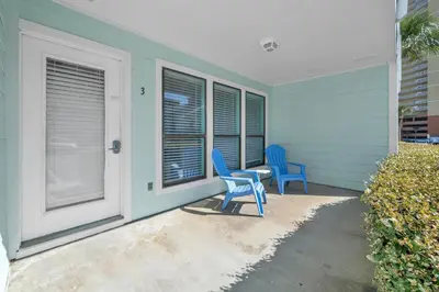 two blue chairs sitting on the porch of a house at Southwind C-3 in Panama City Beach