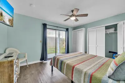 a bedroom with a bed and a ceiling fan at Southwind C-3 in Panama City Beach