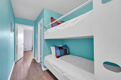 a bedroom with blue walls and a bunk bed at Southwind C-3 in Panama City Beach