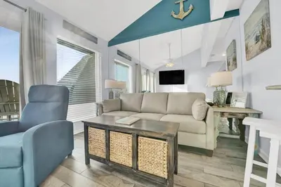 a living room with a couch and a table at Nautical Watch 14 B in Panama City Beach