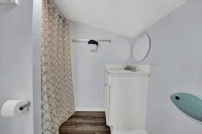 a white bathroom with a sink and a mirror at Nautical Watch 14 B in Panama City Beach