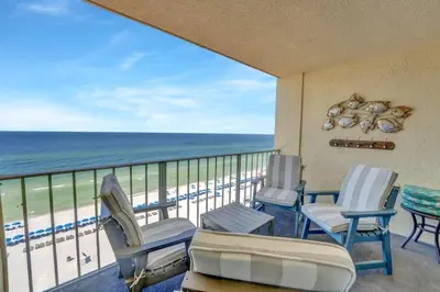 a balcony with chairs and a view of the beach at Regency Towers 1121 in Panama City Beach