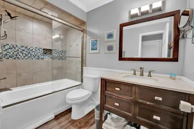 a bathroom with a tub and a toilet and a sink at Regency Towers 1121 in Panama City Beach