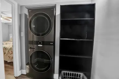 two black washer and dryer in a room at Regency Towers 1121 in Panama City Beach