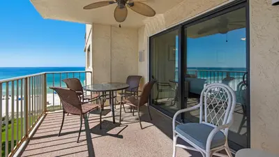 a balcony with a table and chairs and the ocean at Regency Towers Unit 725 in Panama City Beach