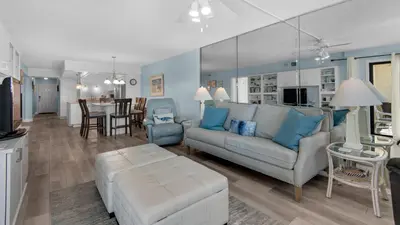 a living room with a couch and a table at Regency Towers Unit 725 in Panama City Beach