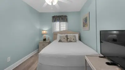 a bedroom with a bed and a flat screen tv at Regency Towers Unit 725 in Panama City Beach