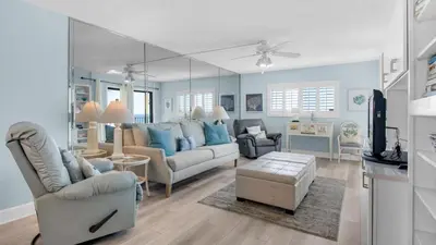 a living room with a couch and a tv at Regency Towers Unit 725 in Panama City Beach