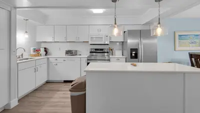 a kitchen with white cabinets and a white counter top at Regency Towers Unit 725 in Panama City Beach