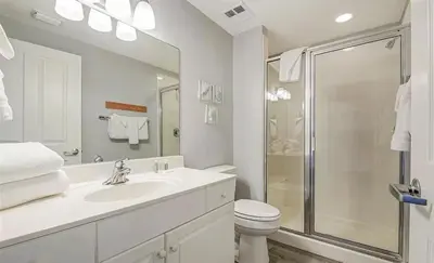 a white bathroom with a sink and a shower at New listing: Gulf/Beach Front Amazing Views in Panama City Beach