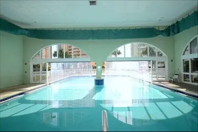 a large swimming pool in a building with windows at New listing: Gulf/Beach Front Amazing Views in Panama City Beach