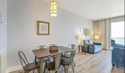 a dining room and living room with a table and chairs at New listing: Gulf/Beach Front Amazing Views in Panama City Beach
