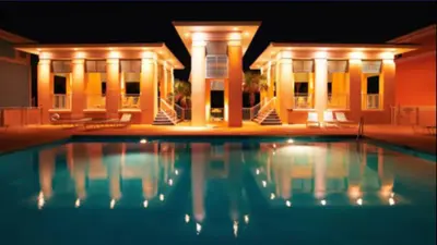 a swimming pool in front of a house at night at New Listing: Water Views, Beach, West end near 30A in Panama City Beach