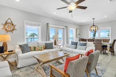 a living room with a couch and a table at 3 Generations Beach House in Watersound Beach