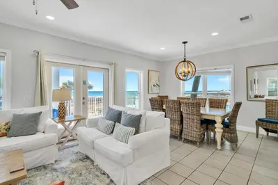 a living room with white furniture and a dining room at 3 Generations Beach House in Watersound Beach