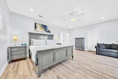 a bedroom with a bed and a couch at 3 Generations Beach House in Watersound Beach