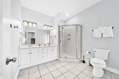 a white bathroom with a shower and a toilet at 3 Generations Beach House in Watersound Beach