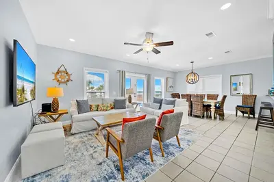 a living room with a couch and a table at 3 Generations Beach House in Watersound Beach