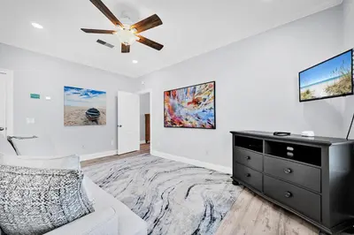 a living room with a couch and a ceiling fan at 3 Generations Beach House in Watersound Beach