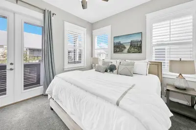 a white bedroom with a large bed and windows at Town of Prominence 67C - Pour Beach Life in Inlet Beach