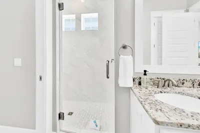 a white bathroom with a shower and a sink at Town of Prominence 67C - Pour Beach Life in Inlet Beach