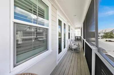 a porch with windows and chairs on a house at Town of Prominence 67C - Pour Beach Life in Inlet Beach