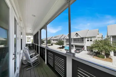 a balcony with a view of a house at Town of Prominence 67C - Pour Beach Life in Inlet Beach