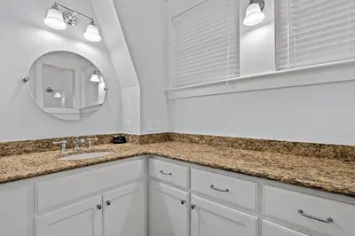 a white bathroom with a sink and a mirror at Almost Heaven in Watersound Proper INCLUDES Carriage House! Bedding for 12 in Rosemary Beach