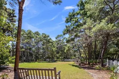a park with benches and trees in a park at Almost Heaven in Watersound Proper INCLUDES Carriage House! Bedding for 12 in Rosemary Beach