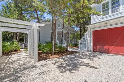 a white house with a red garage at Almost Heaven in Watersound Proper INCLUDES Carriage House! Bedding for 12 in Rosemary Beach