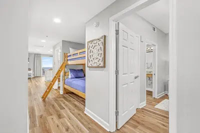 a bedroom with a bed and a bunk bed at Splash Resort Beachfront in Panama City Beach