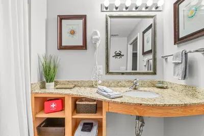 a bathroom with a sink and a mirror at Splash Resort Beachfront in Panama City Beach