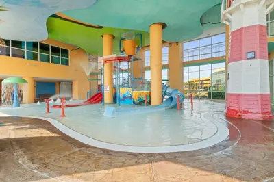 a water park with a water slide in a building at Splash Resort Beachfront in Panama City Beach