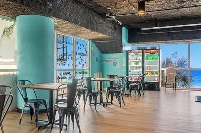 a dining room with tables and chairs in a restaurant at Splash Resort Beachfront in Panama City Beach